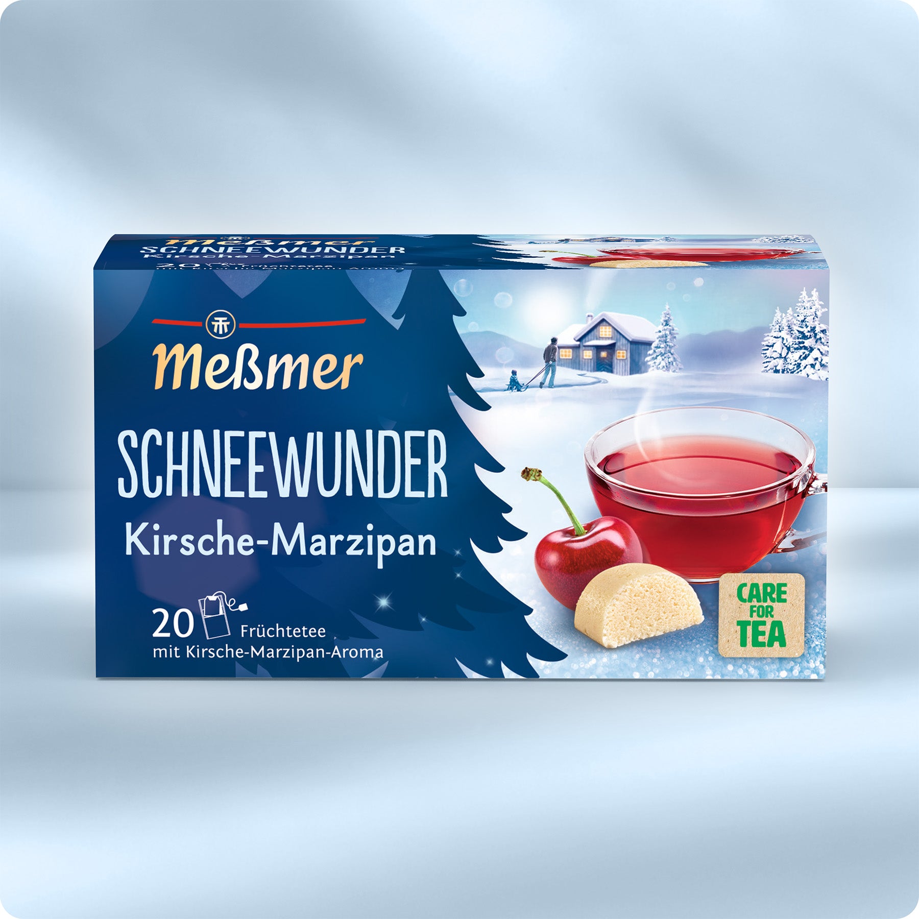 Verpackung von Schneewunder Früchtetee mit Kirsch-Marzipan-Aroma, Abbildungen von Kirsche und Marzipanstück, Teetasse mit rotem Tee, schneebedeckte Winterlandschaft im Hintergrund.