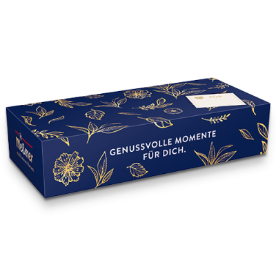 Die Geschenkbox Frühling von Meßmer DE ist eine rechteckige blaue Schachtel mit goldenen Blumenmustern, dem deutschen Text "GENUSS VOLLE MOMENTE FÜR DICH", einem weißen Manner-Logo und einem Hinweis auf die Tee-Auswahl - perfekt, um Teeliebhaber zu beschenken.
