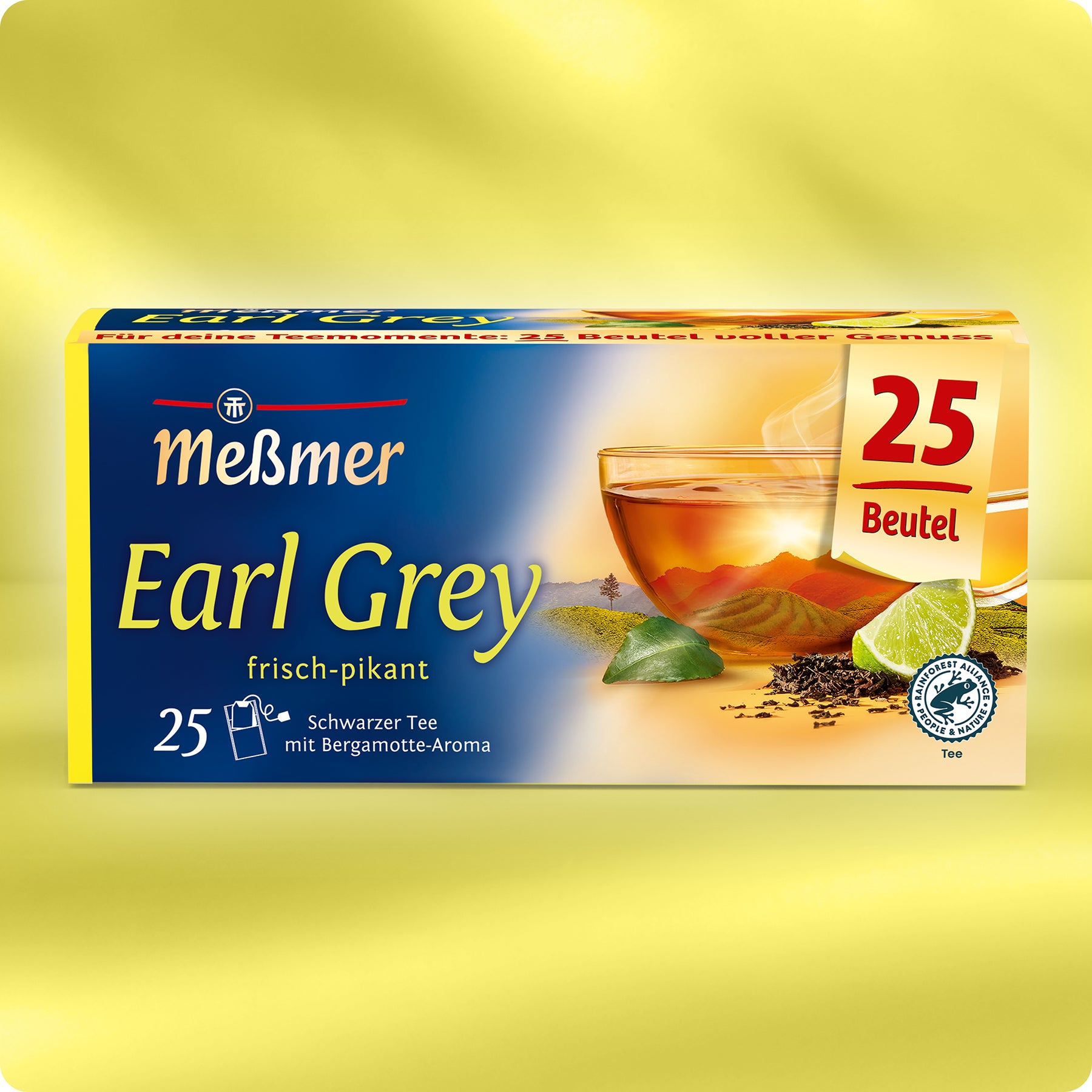 Meßmer DE Earl Grey, 25 Beutel: Die gelbe Schachtel zeigt ein Glas mit schwarzem Tee, Teeblättern und einer Limettenscheibe. Beschrieben als schwarzer Tee mit einer feinen Note von Bergamotte.