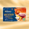 Verpackung von Wintertraum Kräutertee mit Zimtstern-Orange Aroma, dargestellt mit dampfender Teetasse, Zimtsternen und Orangenscheiben vor warmem, weihnachtlichem Hintergrund.