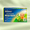 Verpackung von Marokkanische Minze-Honig mit Kräuterteemischung und Honig-Aroma, dargestellt mit Minzblättern, dampfender Teetasse und Wüstenmotiv im Hintergrund.