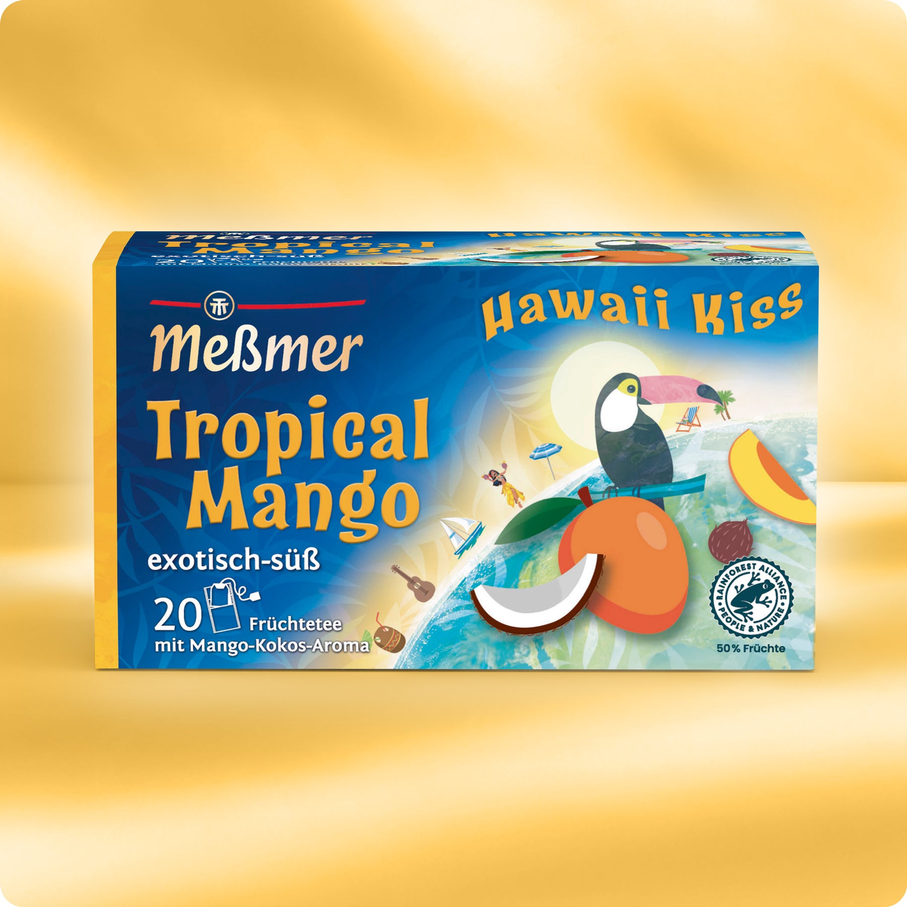 Die farbenfrohe Schachtel Meßmer DE Hawaii Kiss - Tropical Mango Tee mit dem Motiv eines Tukans, einer Mango und einer Kokosnuss enthält 20 Teebeutel und präsentiert den exotisch-süßen tropischen Mango-Kokos-Geschmack.