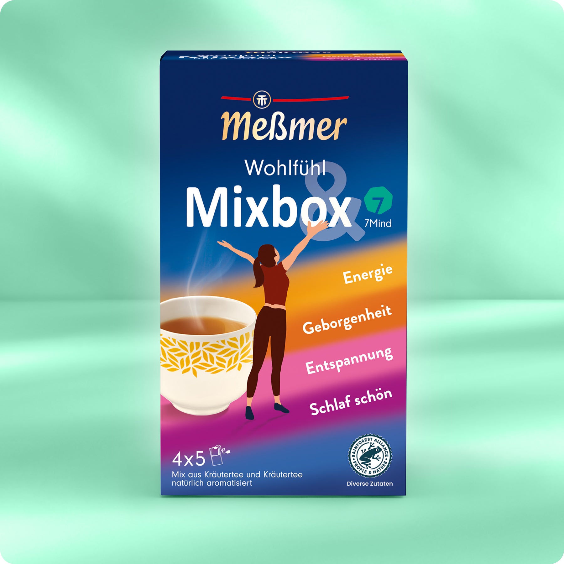 Die Meßmer DE Wohlfühltee Mixbox Kräutertees zeigt eine dampfende Teetasse, eine illustrierte Frau mit erhobenen Armen und bunte Bänder mit den Aufschriften Energie, Geborgenheit, Entspannung & Schlaf schön - der perfekte Wohlfühltee.