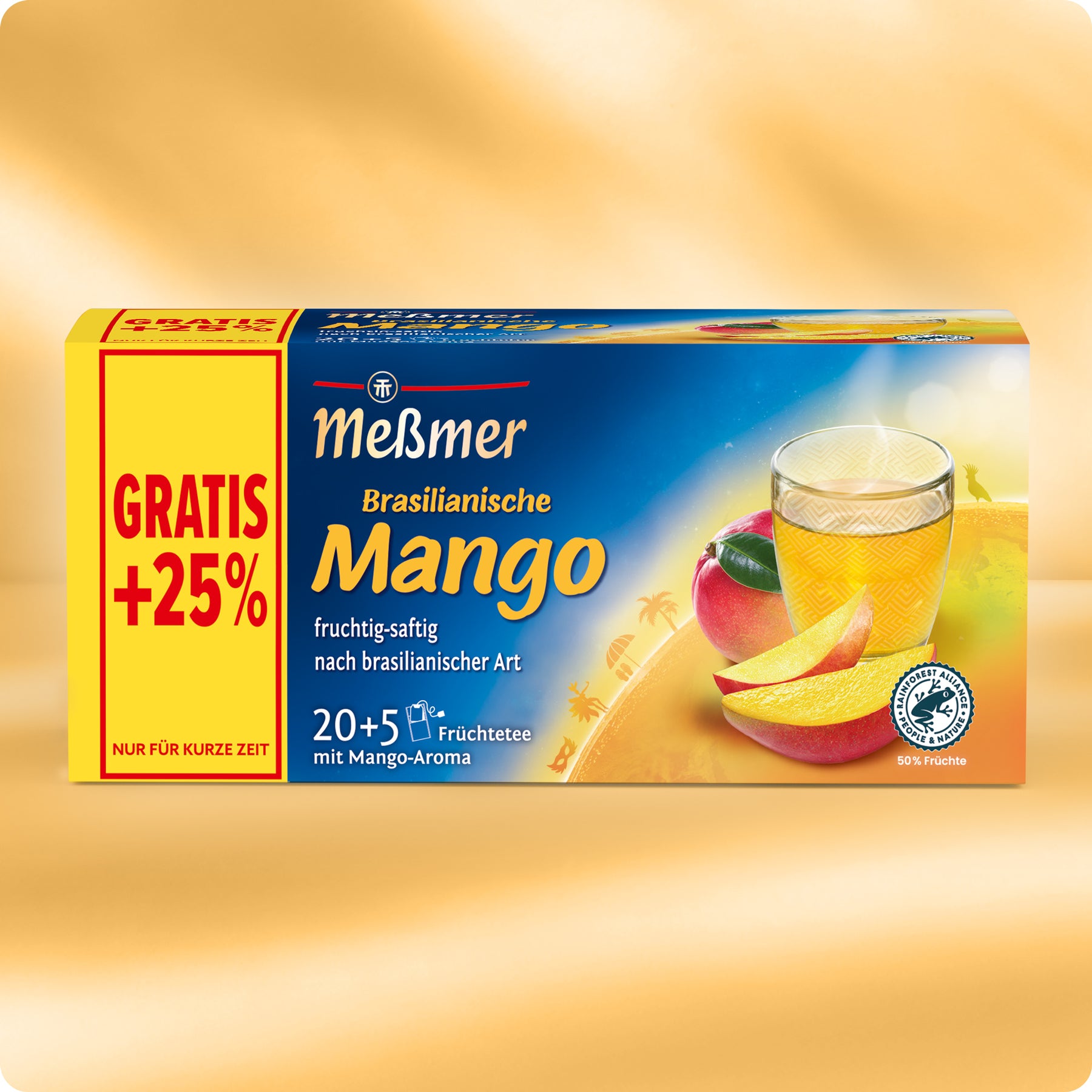 Schachtel Meßmer Brasilianischer Mango-Früchtetee mit einem Glas gelben Tees, einer geschnittenen Mango und einer ganzen Mango auf der Vorderseite. Die Schachtel wirbt in einem gelb-roten Banner mit GRATIS +25%.